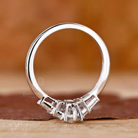 Marquise cut ring featuring trapezoid side stone accents
