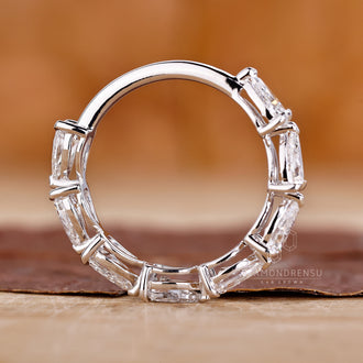 Half-eternity wedding band with claw prong settings.

