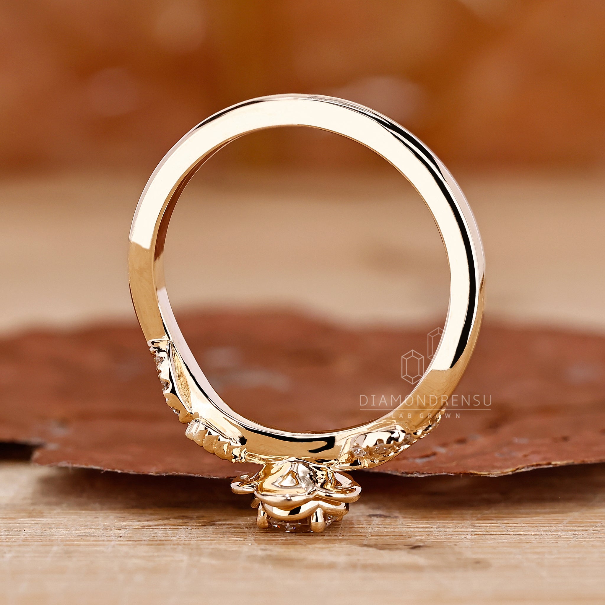 Nature-inspired wedding ring featuring a round diamond and handmade floral details