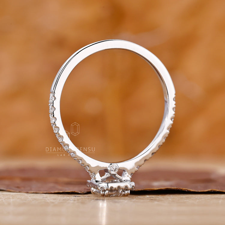 Double prong engagement ring with an emerald cut diamond for a secure fit.
