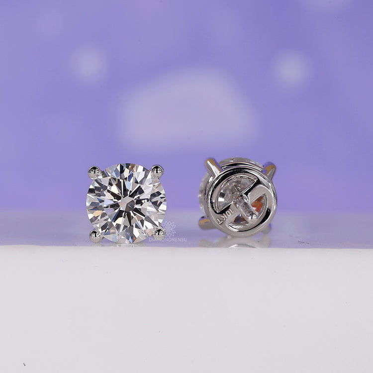 Stud women's earrings in white gold featuring a push in earrings mechanism.
