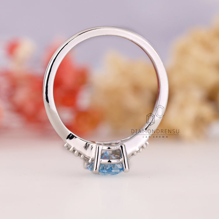 Prong Setting Ring with a blue diamond centerpiece.