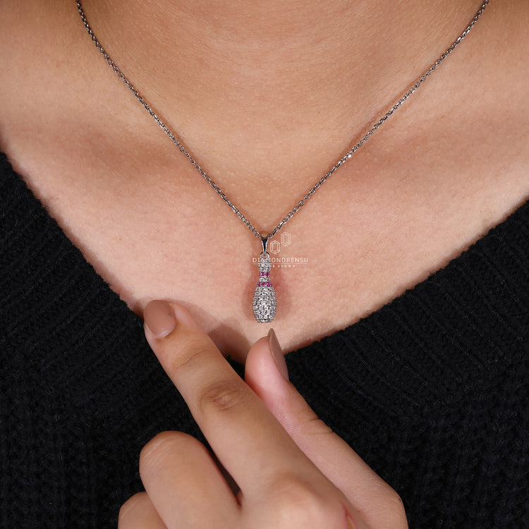 Diamondrensu pendant with Bowling Pin charm and prong set design.
