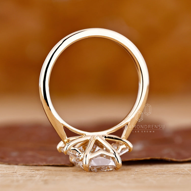 Emerald cut engagement ring with three stone design for added brilliance.
