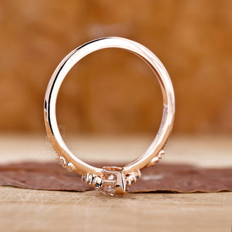Handmade ring with a radiant marquise diamond and a detailed milgrain setting.

