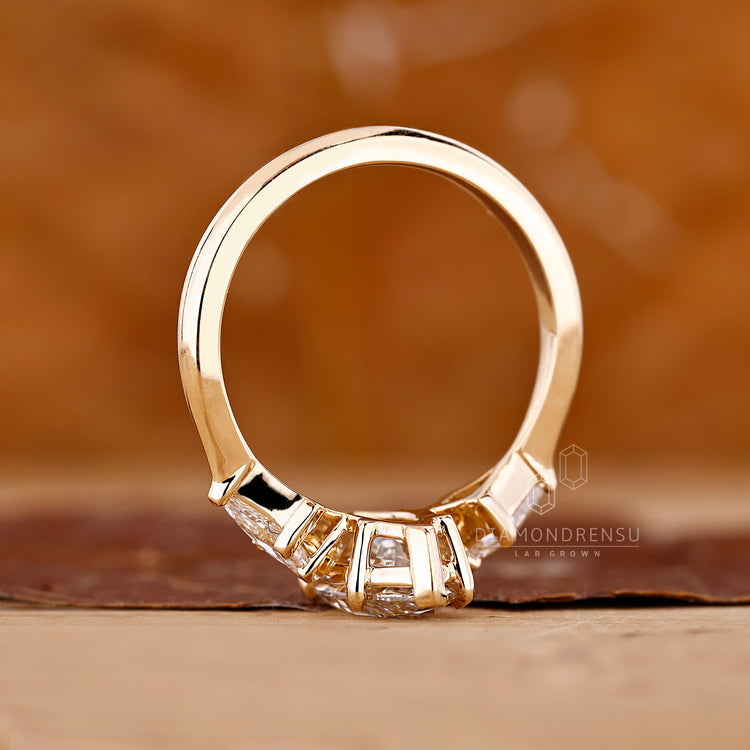 Custom diamond ring with marquise diamond and kite cut side stones.
