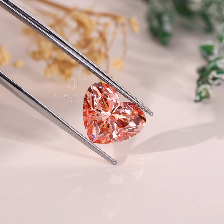 A pink diamond shaped like a heart with 4 carat weight and lab grown brilliance.
