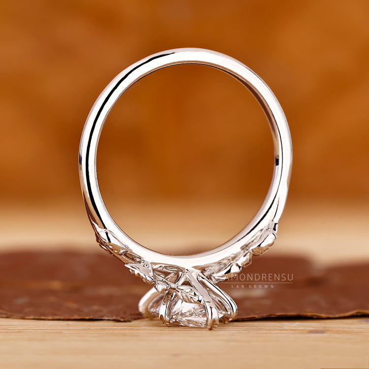 Diamondrensu engagement ring featuring a marquise diamond, designed with round side stones for balance.