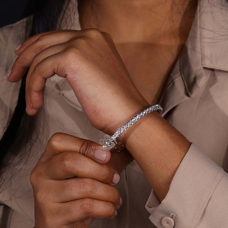 Round diamond bangle bracelet displayed on a jewelry stand
