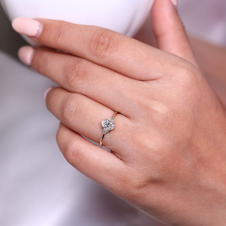 Seven stone ring with oval diamond and round side stones.
