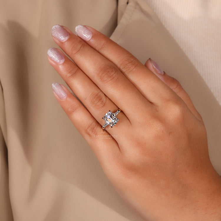 Custom engagement ring with a cushion cut diamond and tapered baguette side stones, designed for her.
