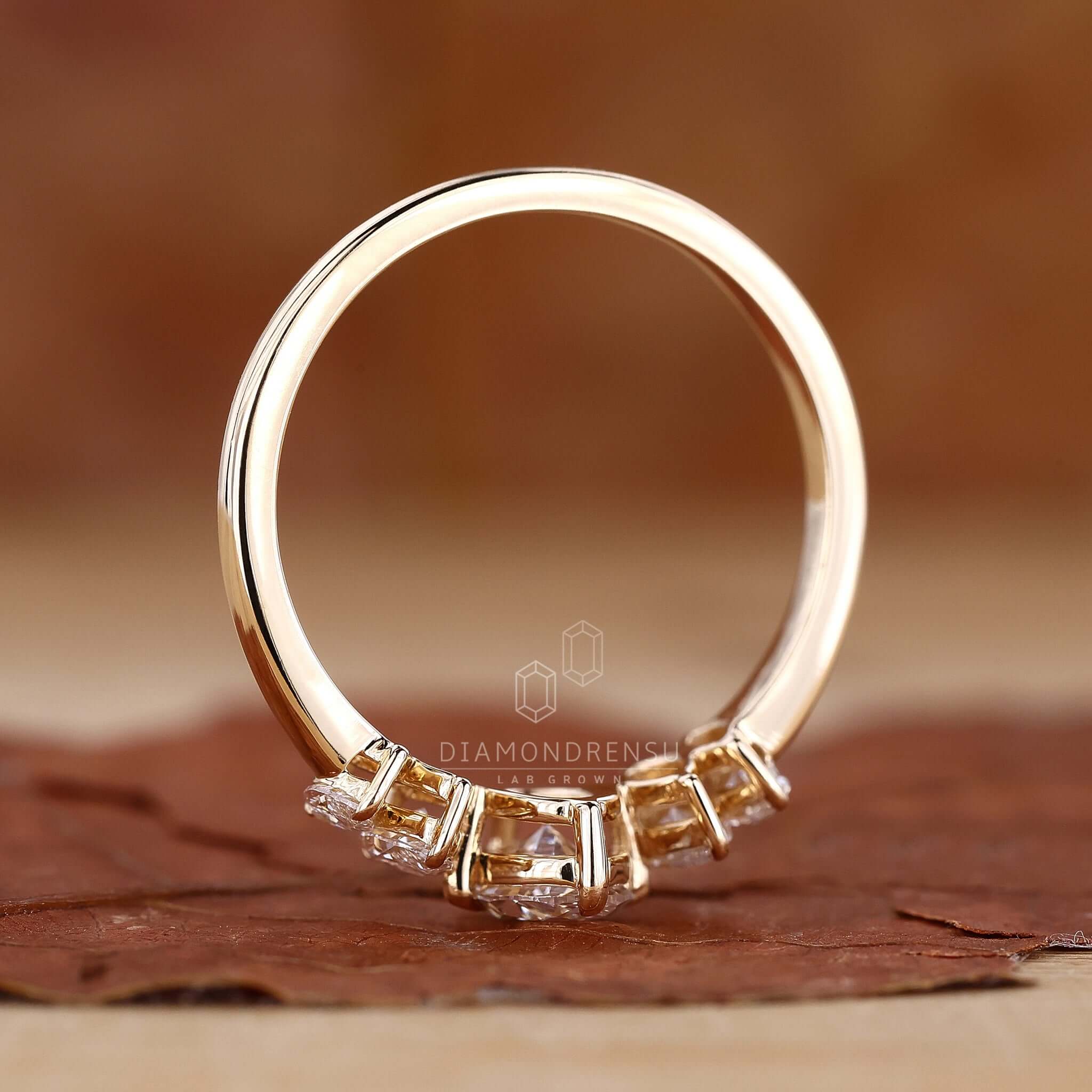 Hand wearing a gold oval diamond engagement ring, emphasizing its radiant elegance and style