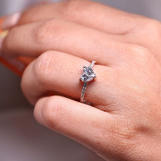 Round cut pave band ring with heart shaped diamond center stone.
