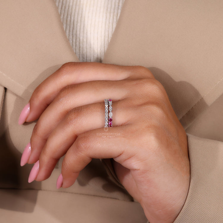 Custom wedding band with ruby and diamond details in white gold.
