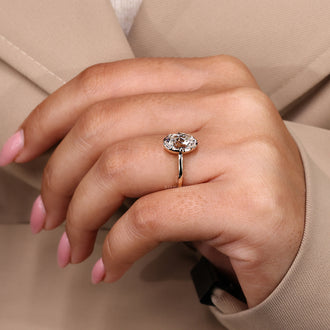 Oval old European cut diamond solitaire ring with yellow gold band.
