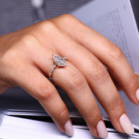 Marquise and round side diamond ring with yellow gold finish.
