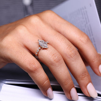 Marquise and round side diamond ring with yellow gold finish.
