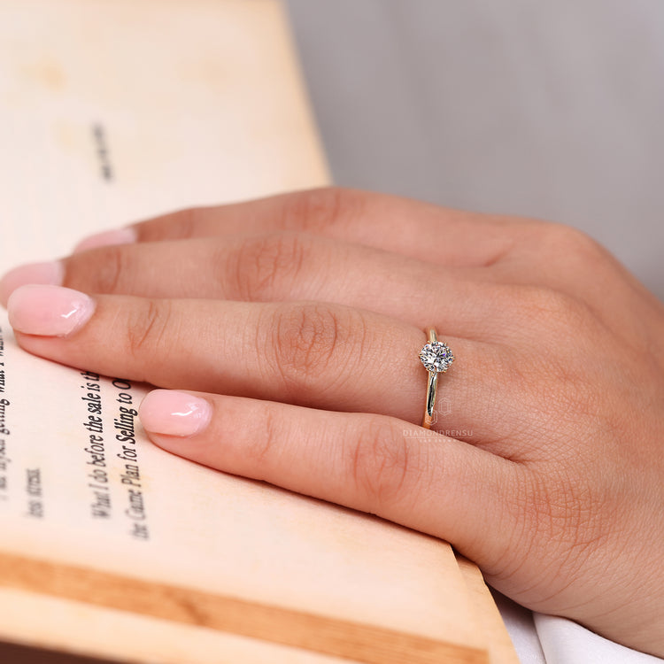 Six claw prong setting round diamond solitaire ring in handmade gold.
