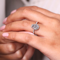 Round cut halo setting with white gold diamond ring.
