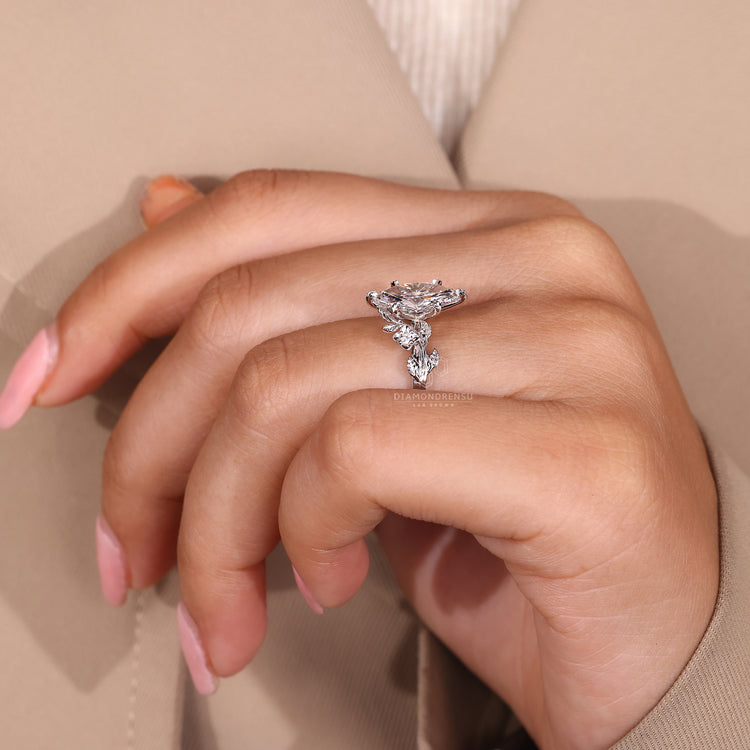 Cluster diamond ring with marquise diamonds and round side stones, set in a white gold band.
