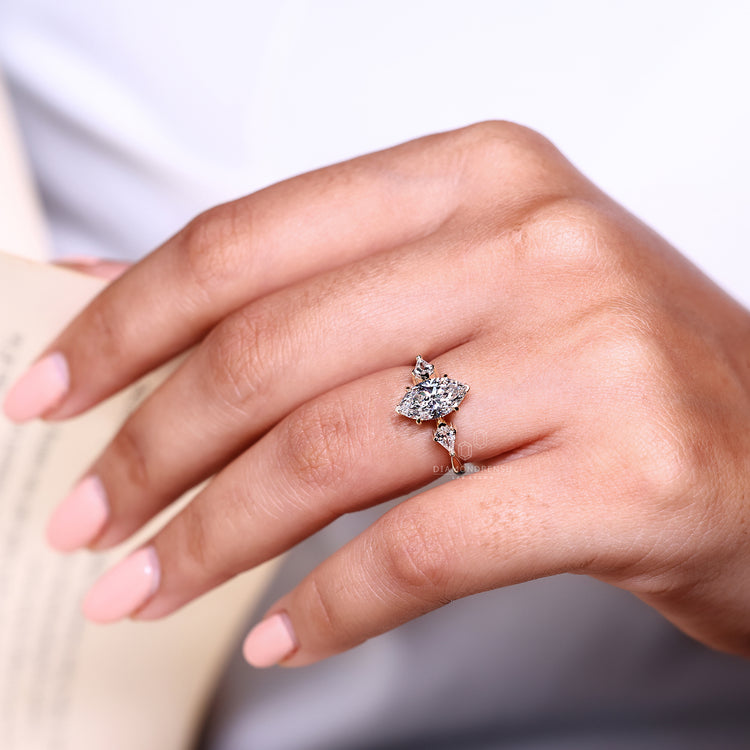 Kite cut side diamond ring paired with marquise center stone.
