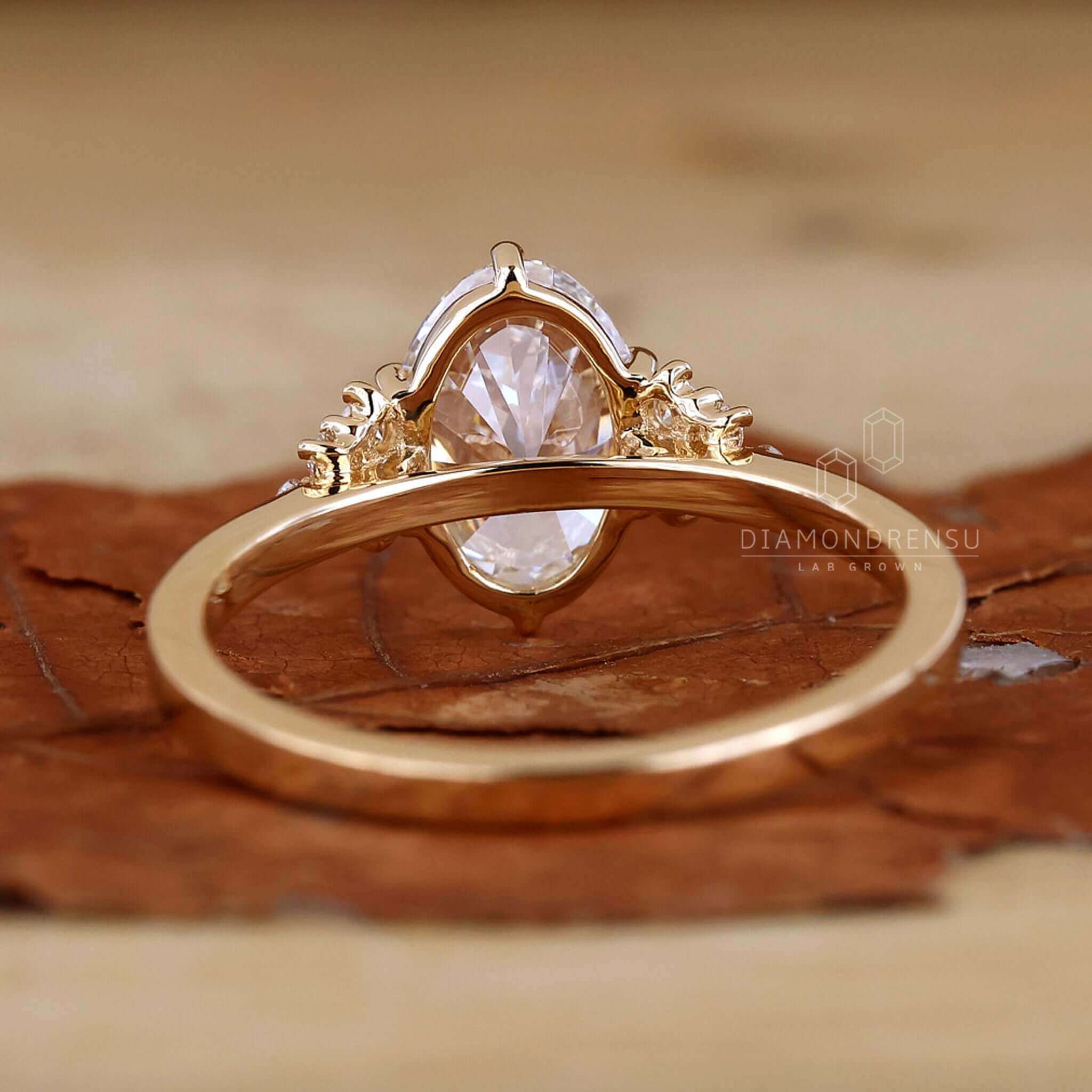 Oval diamond ring with round sidestones on a woman's hand