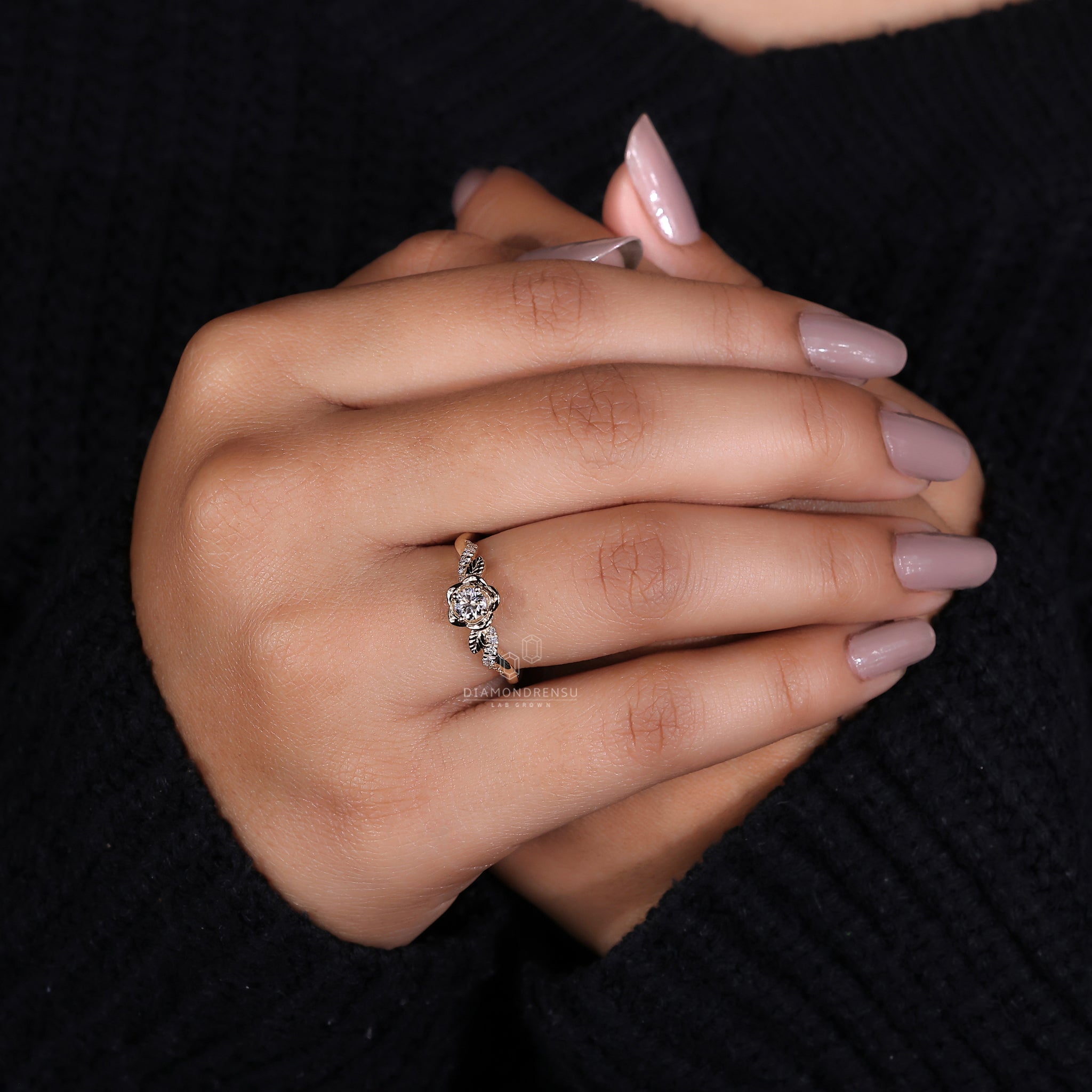 Diamondrensu engagement ring with a round diamond, round prongs, and a nature-inspired floral design