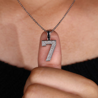 Unique numeric number pendant with round diamond accents in white gold.
