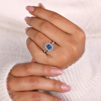 Pave set diamonds in radiant cut blue diamond ring
