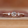 Three stone round engagement ring with compass prongs featuring a Lab Grown Diamond center stone