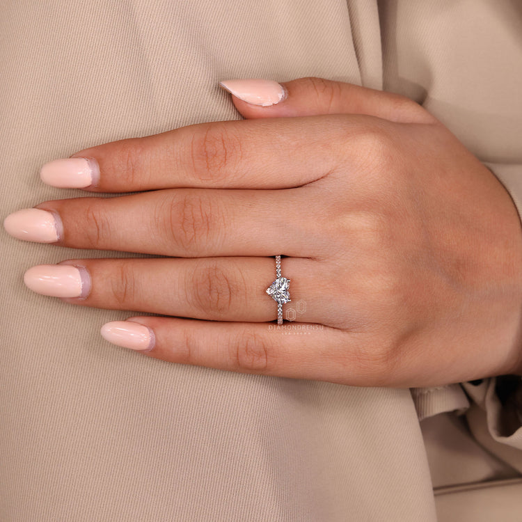 V shaped prong ring holding heart shaped diamond securely in place.
