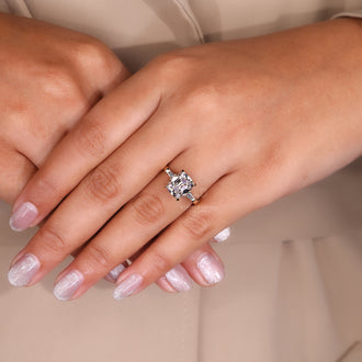 Yellow gold engagement ring with a cushion cut diamond center, offering a classic and warm design.
