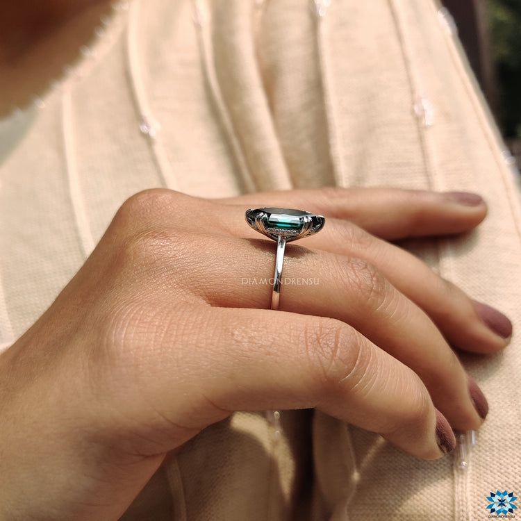 Elegant green Marquise Moissanite engagement ring in white gold.
