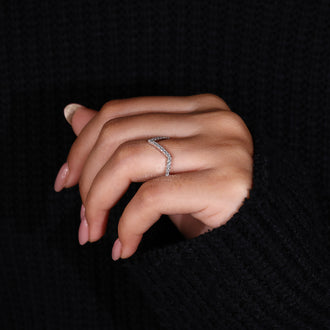 V shaped wedding band complements solitaire engagement rings.
