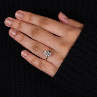 Handmade jewelry featuring a pear-shaped diamond in a prong setting for a personal touch.
