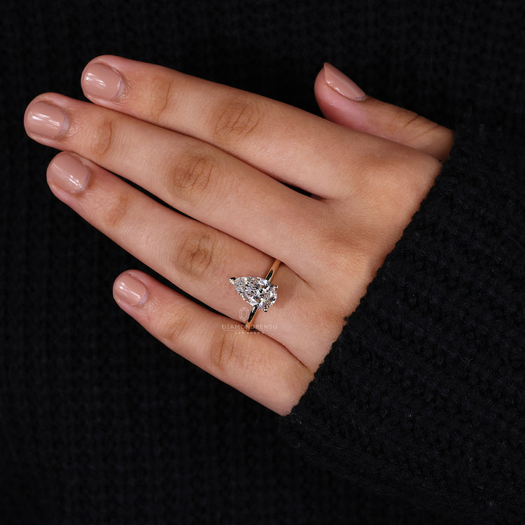 Handmade jewelry featuring a pear-shaped diamond in a prong setting for a personal touch.
