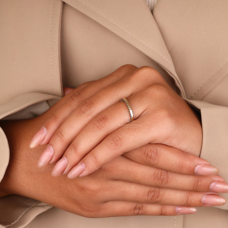 Yellow gold wedding band with a classic eternity setting.
