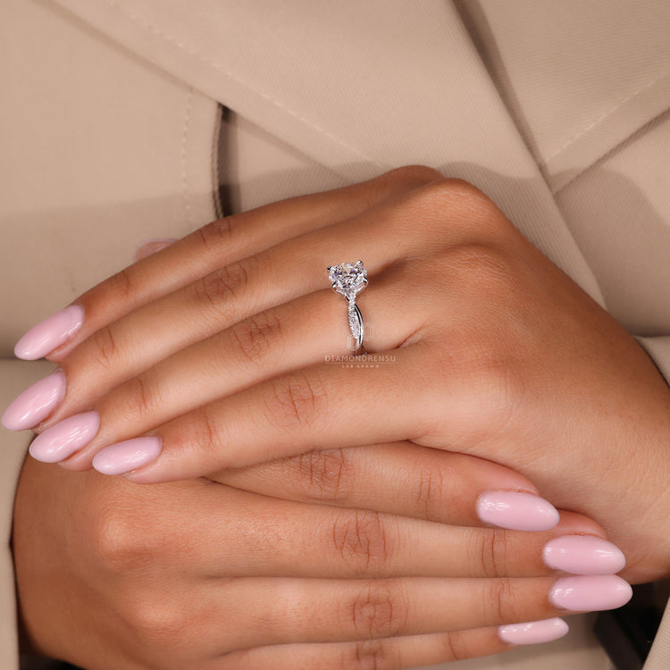 Woman's hand wearing a ring with a tag saying buy engagement ring.
