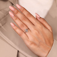 Tapered shank ring featuring marquise diamond and claw prong setting.
