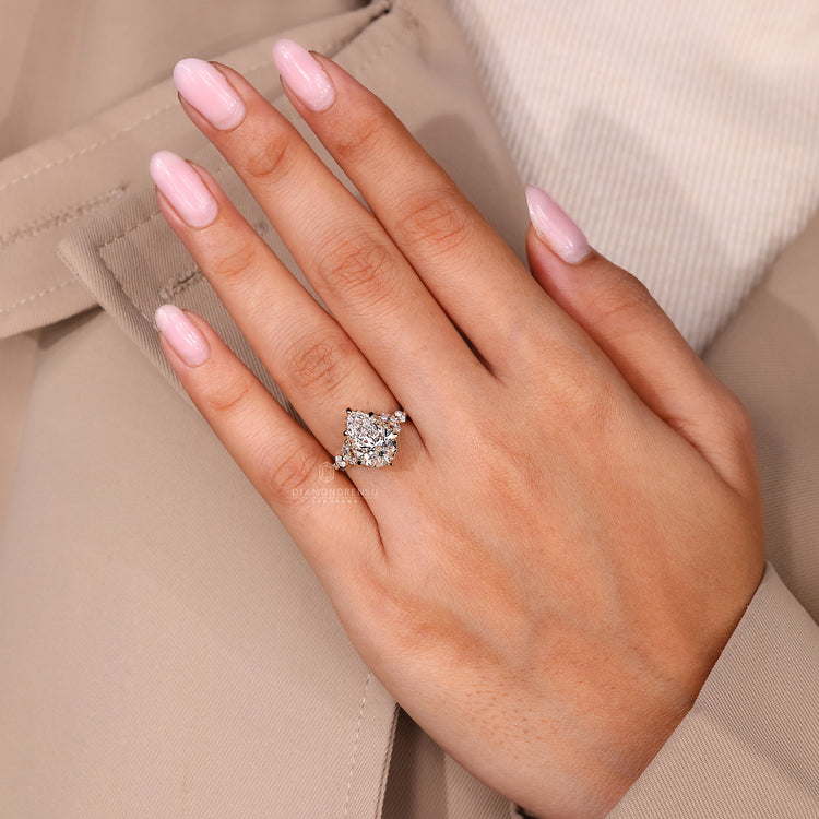 Muse setting ring featuring pear cut diamond with marquise side stones.
