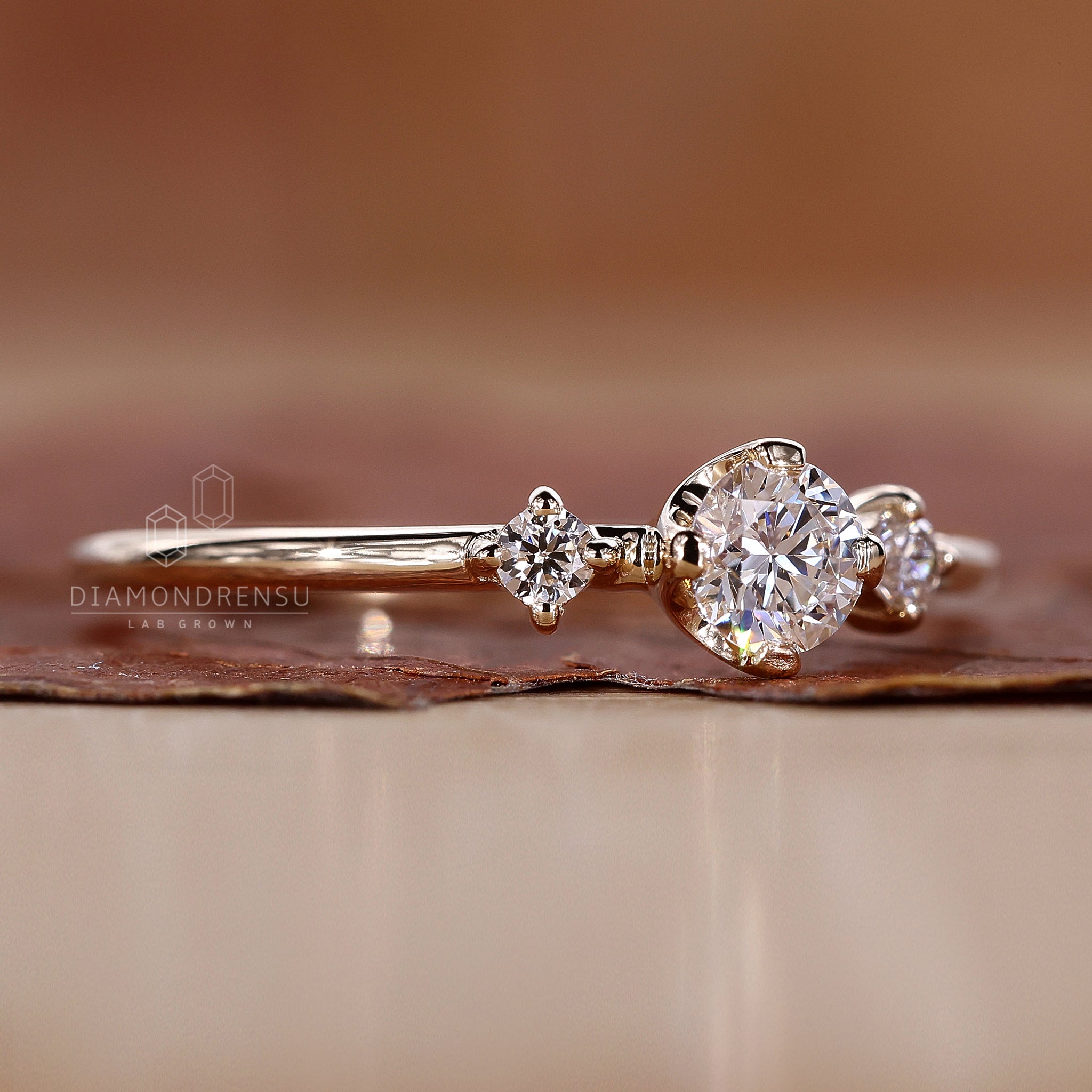 Diamondrensu engagement ring with a three stone round design, featuring Lab Grown Diamonds.