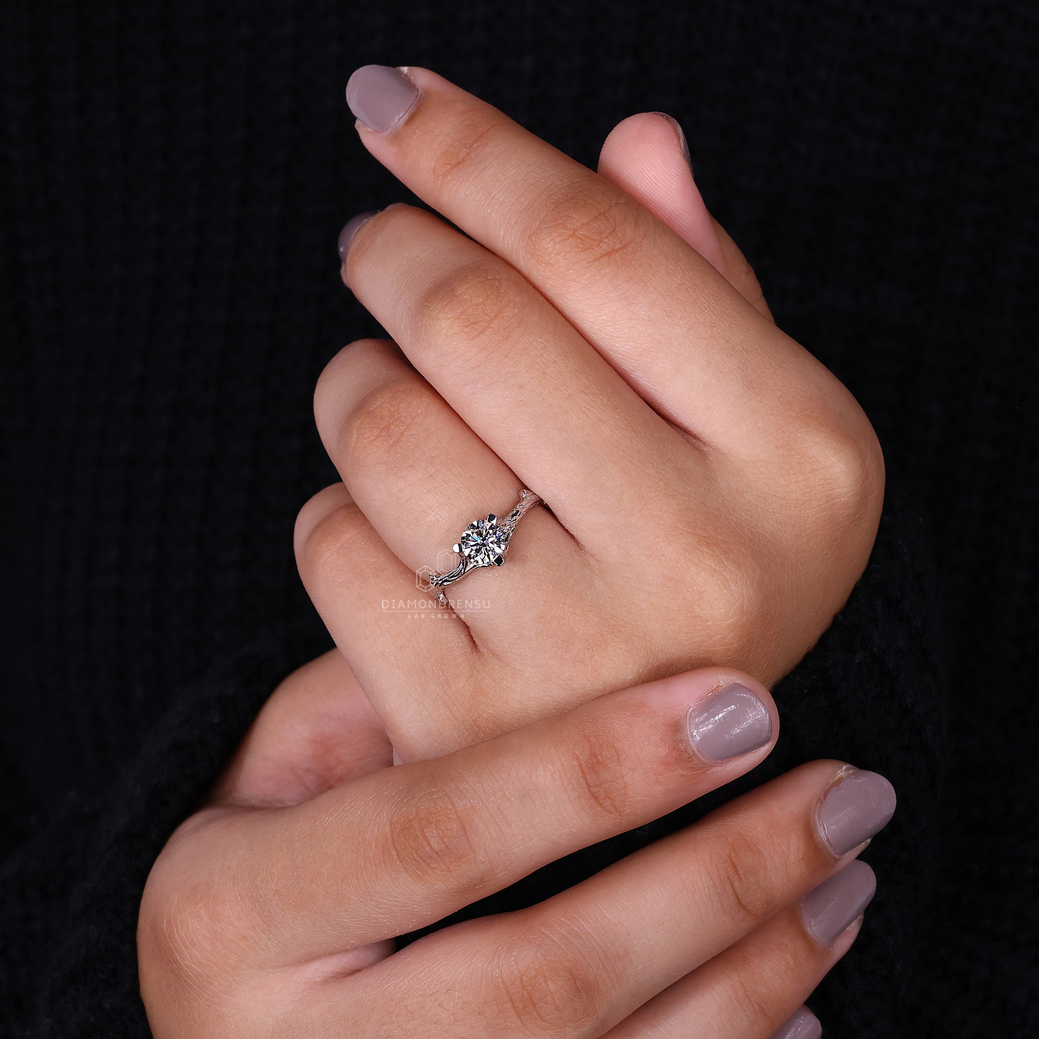 Beautiful nature-inspired engagement ring showcasing a round solitaire diamond and delicate branch accents on a white gold band