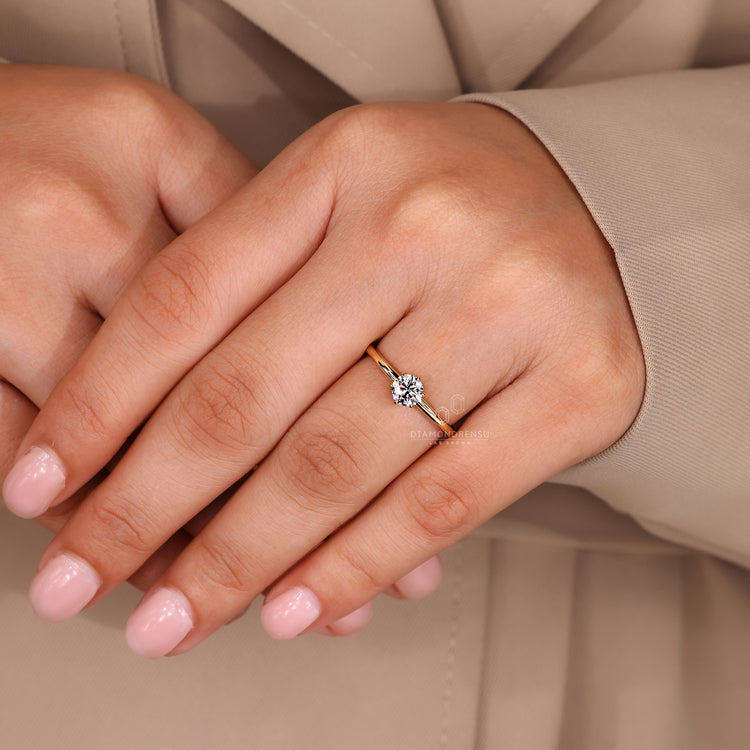 Diamondrensu round brilliant cut engagement ring in a six prong setting.
