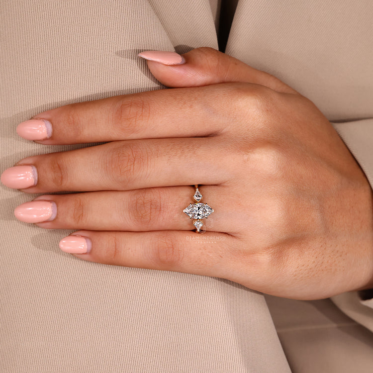Claw prong setting ring with marquise diamond in yellow gold.
