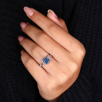 Custom engagement ring with an elongated cushion ring and dazzling side stones.
