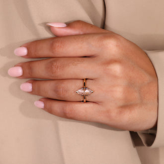 Marquise diamond ring with tapered shank design.