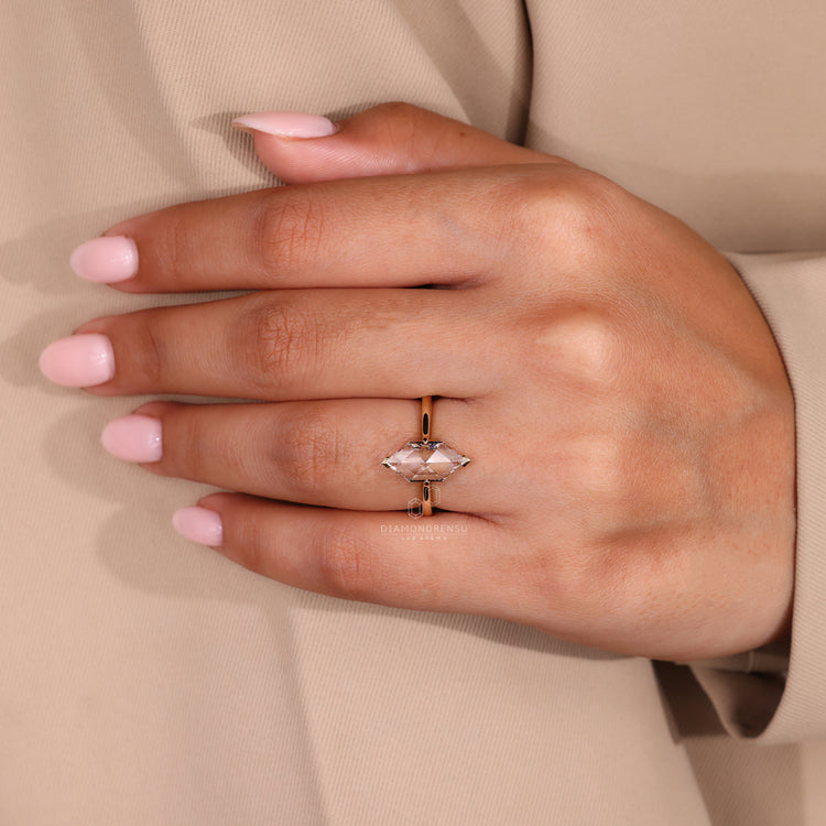 Marquise diamond ring with tapered shank design.