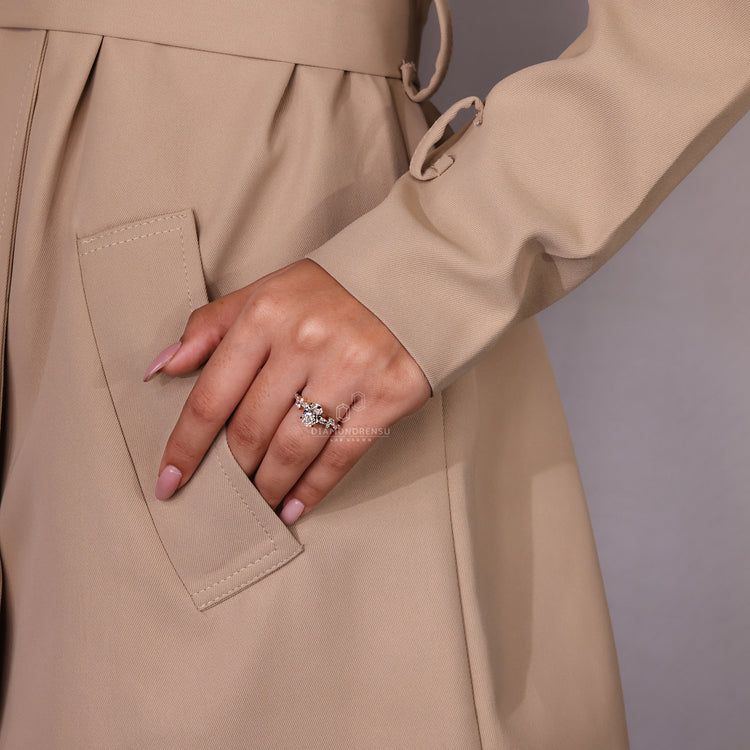 Round diamond side stones accentuate this elegant oval engagement ring.