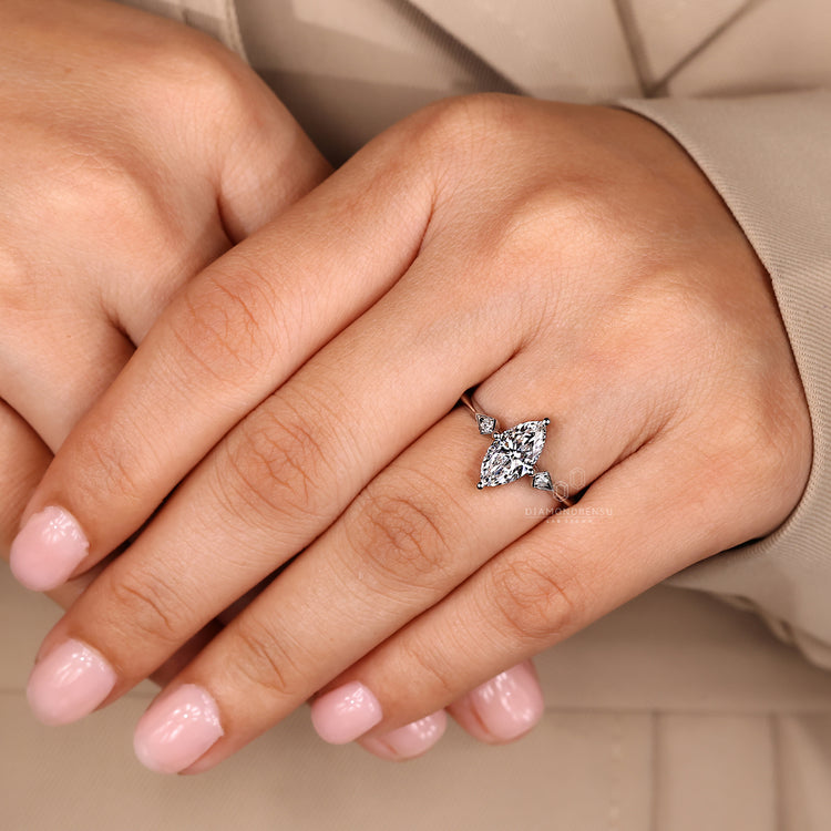 Buy diamond ring with marquise and round three stone arrangement.
