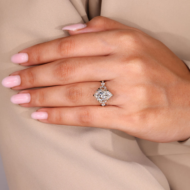 Cathedral setting ring holding pear cut diamond and hidden halo securely.

